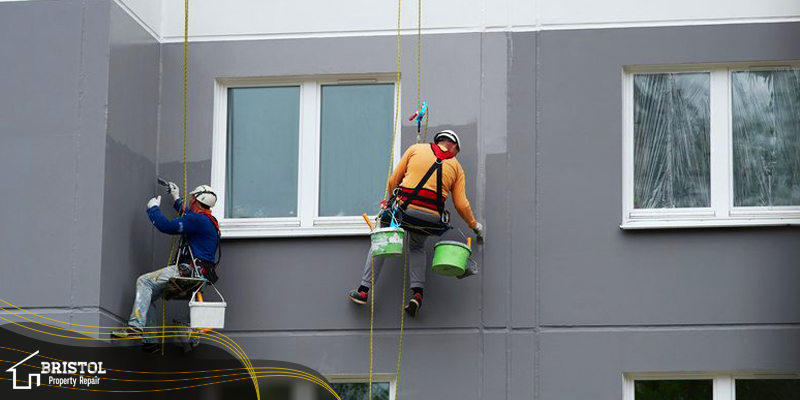 Two men suspended in the air Building Painting Near Me